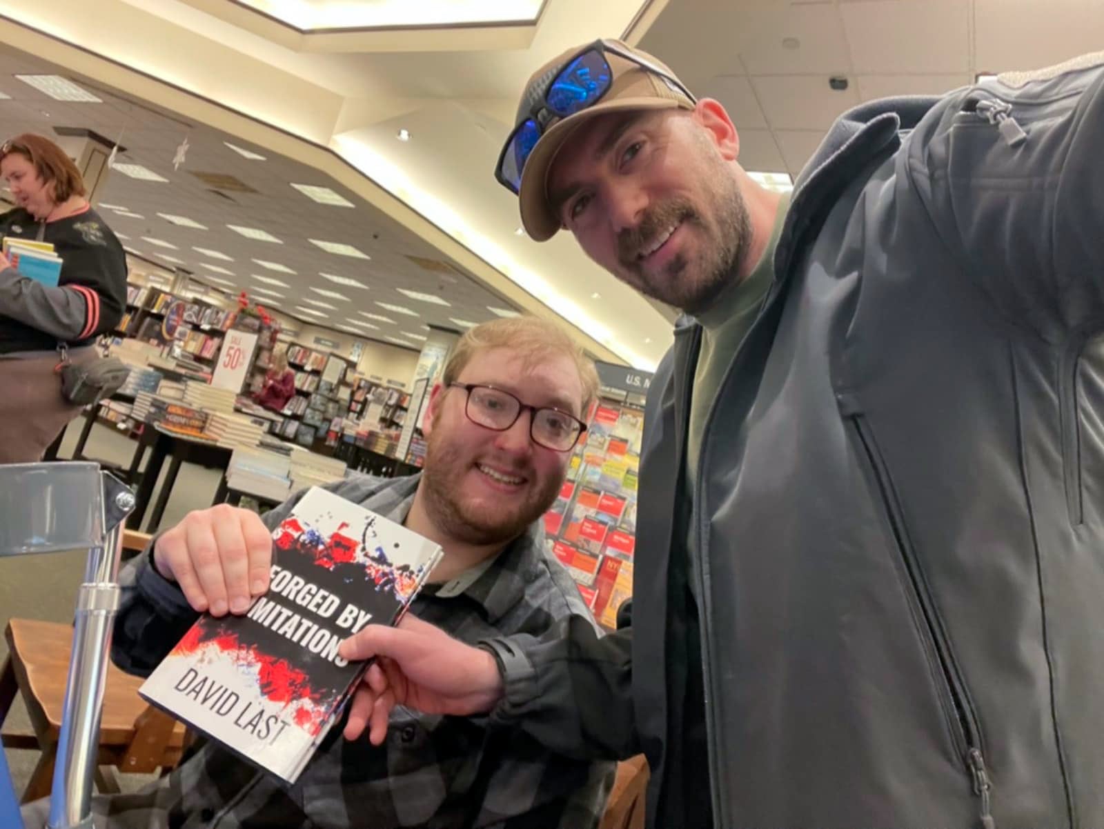 David Last holding Forged by Limitations at a bookstore